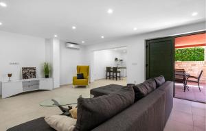 a living room with a couch and a glass table at Stunning Home In Zaboric With Sauna in Zaboric