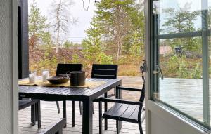 a table and chairs on a porch with a view at Stunning Home In Bjorli With Wifi in Bjorli +24 photos