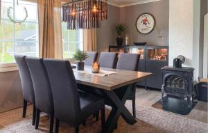 a dining room table with chairs and a wood stove at Stunning Home In Bjorli With Wifi in Bjorli
