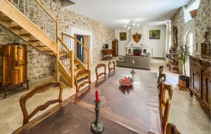 a dining room with a table and a living room at Maison Piscine Proche Arles in Tarascon