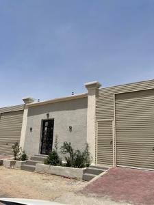 a building with a garage door and some stairs at شاليهات جاليكا in Taif