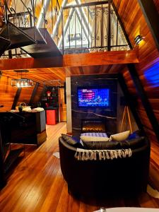 a living room with a couch and a fireplace at Chalé Super Luxo Monte Lorobell in Campos do Jordão +20 photos