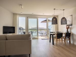 a living room with a couch and a table at Apartment in Kortgene with Harbor Views in Kortgene