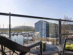 a balcony with a table and a view of a marina at Apartment in Kortgene with Harbor View in Kortgene