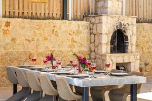 a table with wine glasses and flowers on it at Villa Guney in Kas