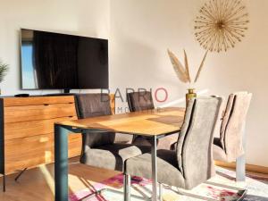 a dining room with a wooden table and chairs at Appartement T2 à Banyuls-sur-Mer, Loggia et Parking - FR-1-309-519 in Banyuls-sur-Mer