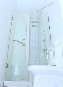 a bathroom with a shower and a toilet and a sink at Jay Homes in Lagos +17 photos