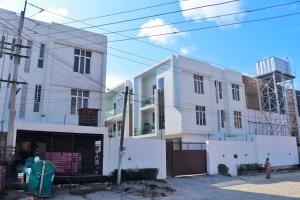 a white building with a gate in front of it at Jay Homes in Lagos