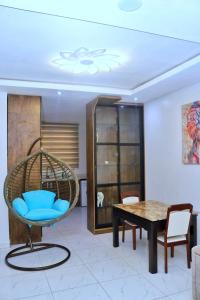 a room with a blue chair and a table at Jay Homes in Lagos