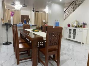 a kitchen with a table and chairs in a room at Agoos View Transient Home in Agoo