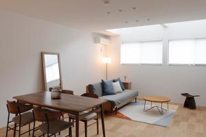 a living room with a couch and a table at LIRI 葵 3min to JR弁天町 Direct to USJ & Umeda & EXPO in Osaka