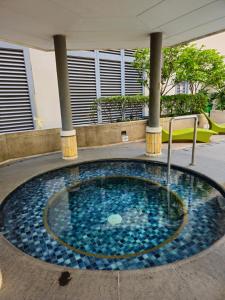 a small pool of water in the middle of a building at Stylish New Studio at McKinley Hill BGC Free Netflix in Manila