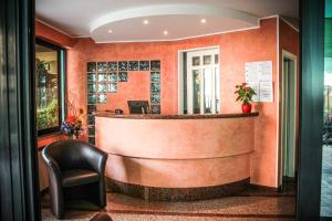 a bar in a hotel lobby with a chair at Hotel Holiday in San Benedetto del Tronto
