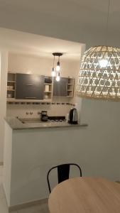 a kitchen with a table and a stove top oven at Departamento Boulevard in Santa Fe