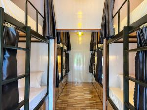 a corridor of a dorm room with bunk beds at Forest Sunset hostel in Ninh Binh +52 photos
