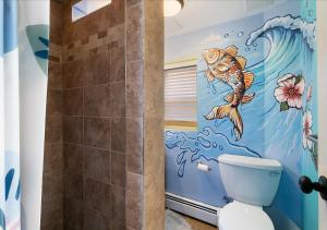 a bathroom with a painting of a fish on the wall at Artistic Oceanfront 2 Bedroom on the beach, Parking Beach Badges fun for all ages in Seaside Heights +8 photos