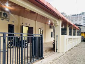 a building with a gate and a motorcycle parked outside at RedDoorz near Jalan Malioboro Area in Ngabean