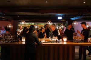 a group of people standing at a bar at Hotel Indigo Brisbane City Centre by IHG in Brisbane +43 photos