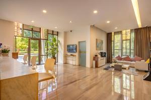 a living room with a couch and a table at Green Court Premier Jinqiao Shanghai in Shanghai