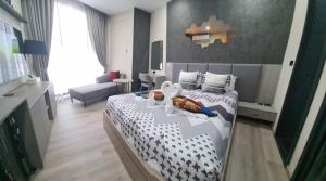 a bedroom with a bed with two swans on it at The Edge Central Pattaya - Unique & Luxurious in Pattaya Central