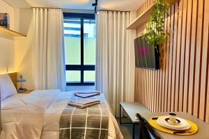 Letto o letti in una camera di AMÁVEl, Studio com Ar Condicionado e Tv Smart