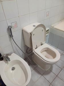 a bathroom with a toilet and a sink at Partition in a shared apartment for rent in Abu Dhabi