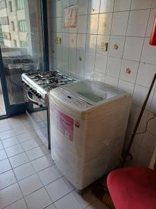 a kitchen with a stove and a refrigerator at Partition in a shared apartment for rent in Abu Dhabi