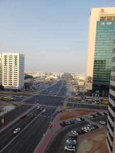 a city street with cars parked in a parking lot at Partition in a shared apartment for rent in Abu Dhabi