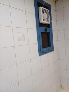 a bathroom with a air conditioner on a wall at Partition in a shared apartment for rent in Abu Dhabi