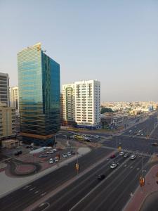 a city with buildings and a highway with cars at Partition in a shared apartment for rent in Abu Dhabi