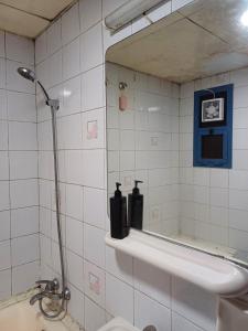a bathroom with a mirror and a sink and a toilet at Partition in a shared apartment for rent in Abu Dhabi