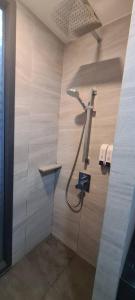 a shower in a bathroom with a wall at The Edge Central Pattaya - Unique & Luxurious in Pattaya Central +75 photos