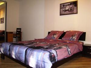 a bedroom with a large bed with red sheets at Pleasure Apartment near center of Odessa in Odesa +27 photos