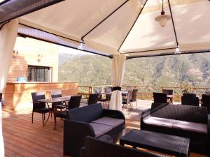 a gazebo with a table and chairs at Maison d'Hôtes Zella in Bains de Guitera