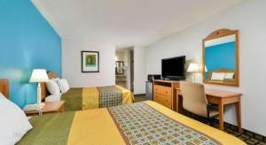 a hotel room with two beds and a desk at Americas Best Value Inn Elizabethtown in Elizabethtown
