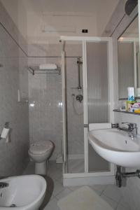 a bathroom with a shower and a sink and a toilet at Hotel Vera in Marina di Massa +22 photos