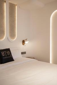 a bedroom with a white bed and two lights at Town Designer B&B in Qingdao