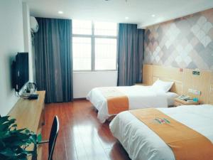 a hotel room with two beds and a television at PAI Hotel·Xuzhou Pei Country, Yangtun Economic and Technological Development Zone Shiliu K in Datun +13 photos
