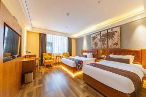 TV a/nebo společenská místnost v ubytování James Joyce Coffetel Guangyuan High-Speed Railway Station Dongba Municipal Government