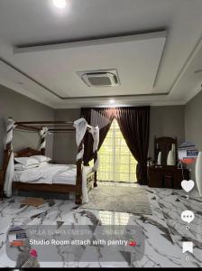 a bedroom with a bed and a large window at Suria guesthouse in Kampung Raja +15 photos