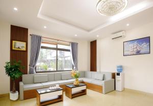 a living room with a couch and a window at Nhà Khách 258 - Sea Front - Near Mikazuki - 500m in Da Nang