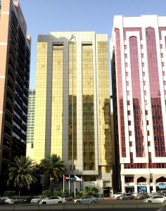 a group of buildings with cars parked in front of them at Al Rawda Arjaan by Rotana, Abu Dhabi in Abu Dhabi