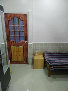 Zimmer mit einer Tür, einem Bett und einem Fenster in der Unterkunft Richmax pg in Jāmb + 2 Fotos