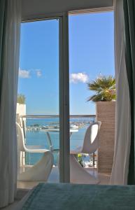a room with a balcony with a view of the ocean at Hostal Brisa Marina in Port d'Alcudia