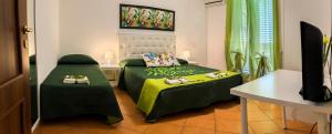 a bedroom with two beds with shoes on them at B&B La Stella di Naxos in Giardini Naxos