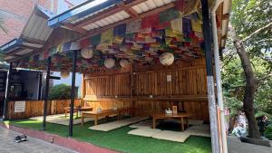 a building with two tables and a colorful wall at Trekking Lodge Nepal in Kathmandu