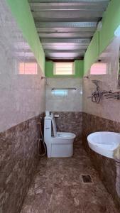 a bathroom with a toilet and a sink at Trekking Lodge Nepal in Kathmandu