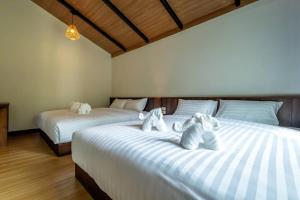 Postel nebo postele na pokoji v ubytování Hom I Din Farm and Homestay
