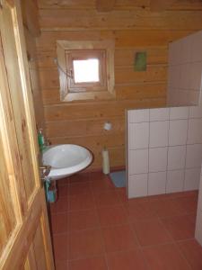 a bathroom with a white sink and a window at Drevenica Hrabušice in Hrabušice