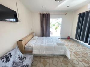 Postel nebo postele na pokoji v ubytování Oh Taley Resort